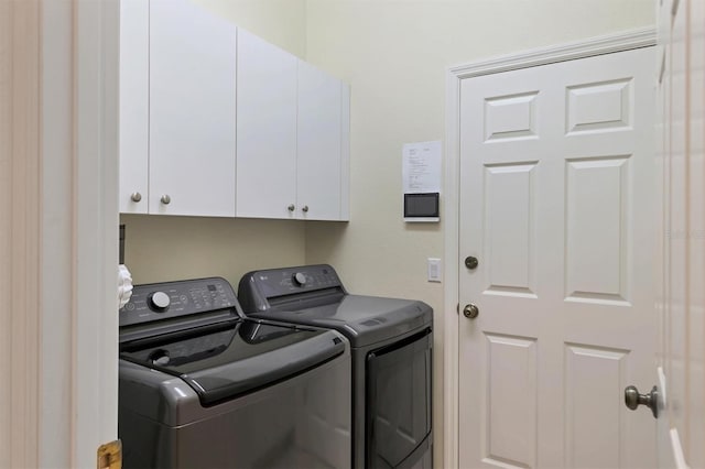 laundry area featuring cabinets and washing machine and clothes dryer