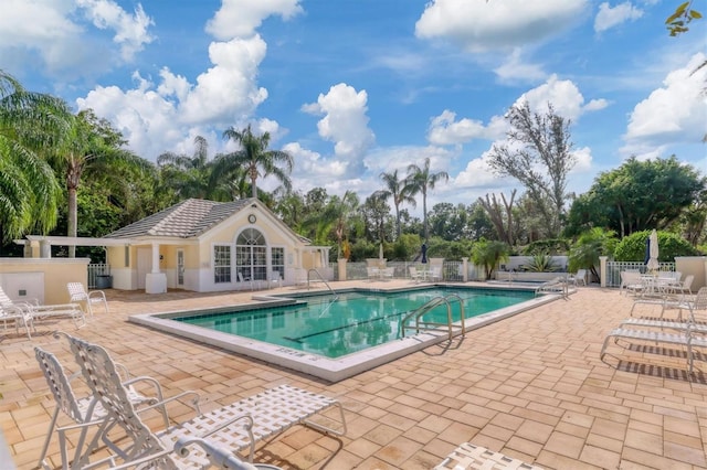 view of swimming pool featuring an outdoor structure and a patio area