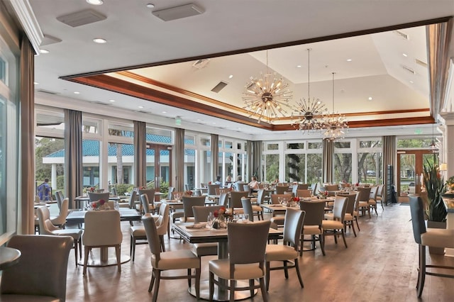 dining space featuring crown molding, a tray ceiling, and a chandelier