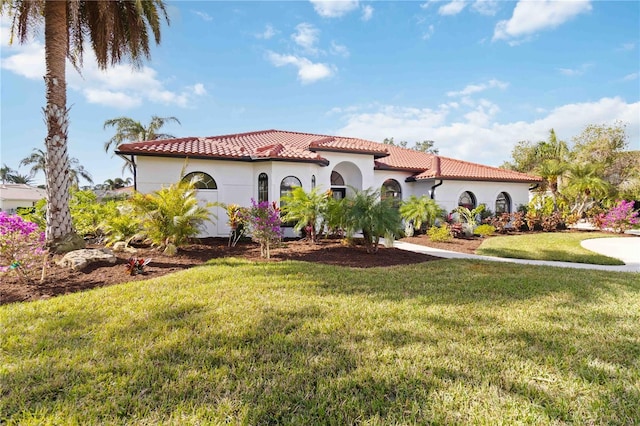 mediterranean / spanish house with a front yard