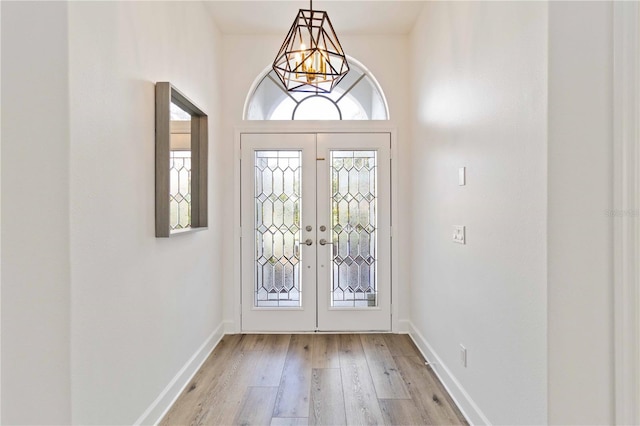 foyer featuring french doors and light hardwood / wood-style floors