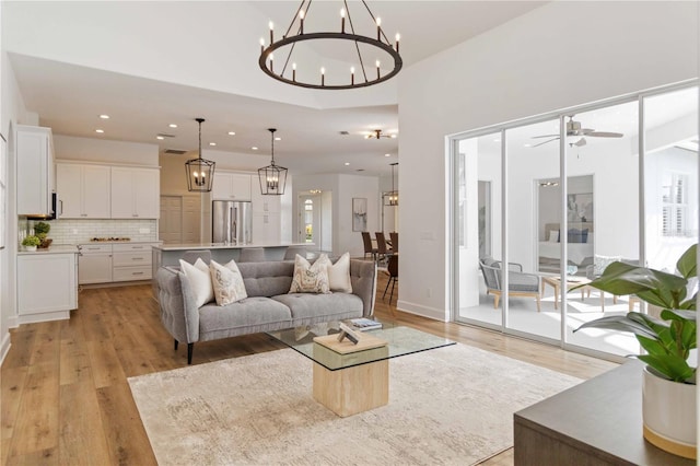 living room featuring light hardwood / wood-style floors and ceiling fan