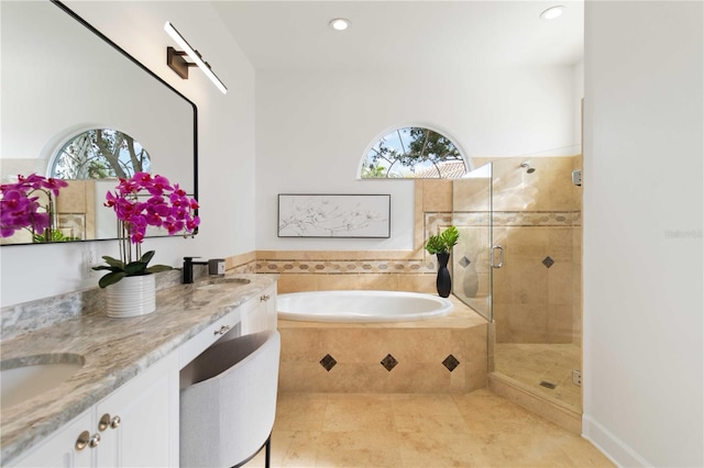 bathroom with shower with separate bathtub, vanity, tile patterned floors, and plenty of natural light