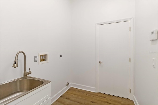 washroom featuring electric dryer hookup, hookup for a washing machine, sink, and light wood-type flooring