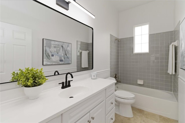 full bathroom featuring toilet, vanity, tile patterned floors, and tiled shower / bath