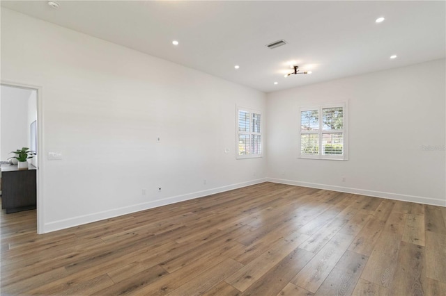 unfurnished room with hardwood / wood-style flooring