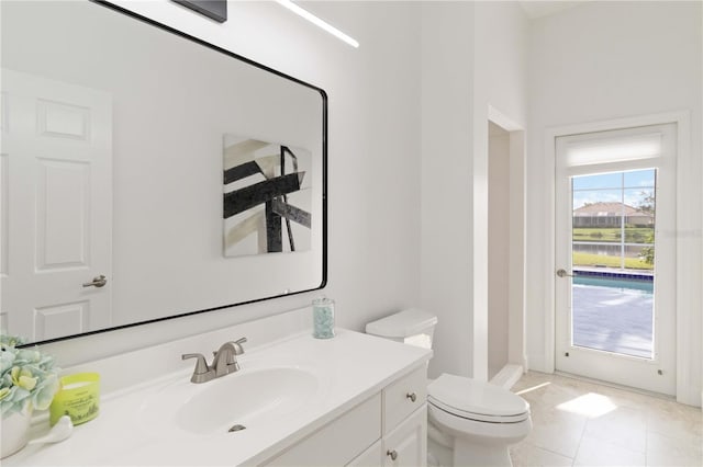 bathroom featuring tile patterned floors, vanity, and toilet