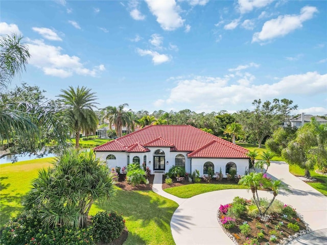 mediterranean / spanish house featuring a front yard