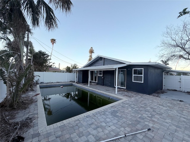 exterior space featuring a patio and a fenced in pool