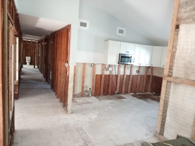 corridor featuring high vaulted ceiling