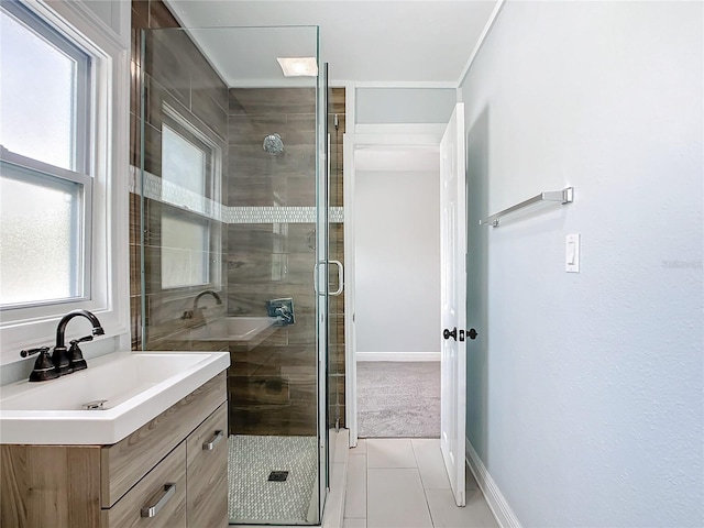 bathroom with tile patterned flooring, vanity, and walk in shower