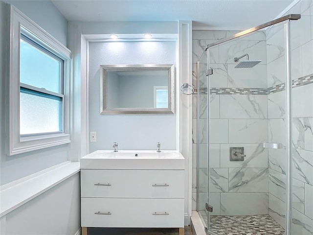 bathroom with vanity and a shower with shower door