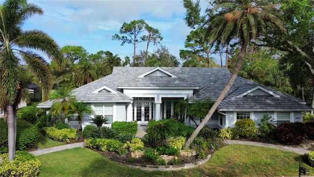 view of front of property featuring a front yard and french doors