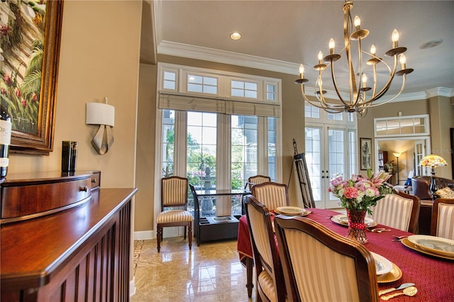 dining area featuring a notable chandelier, ornamental molding, and french doors