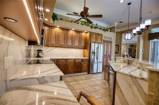 kitchen with sink, light stone countertops, ornamental molding, light tile patterned floors, and stainless steel appliances