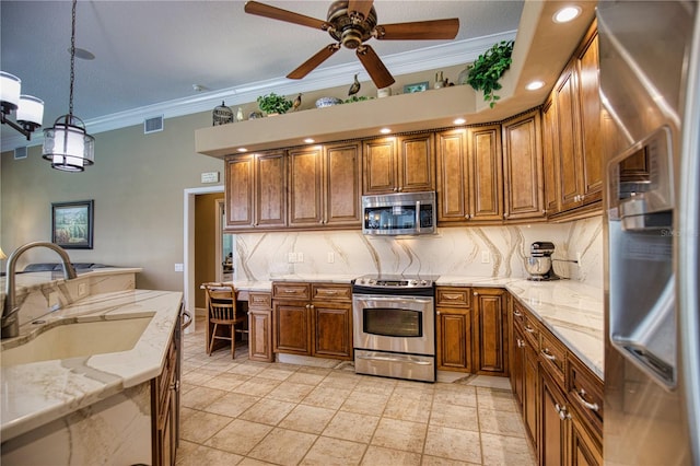 kitchen featuring sink, decorative backsplash, ornamental molding, appliances with stainless steel finishes, and decorative light fixtures