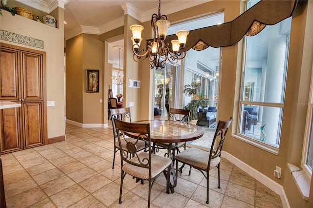 dining room featuring ornamental molding and an inviting chandelier