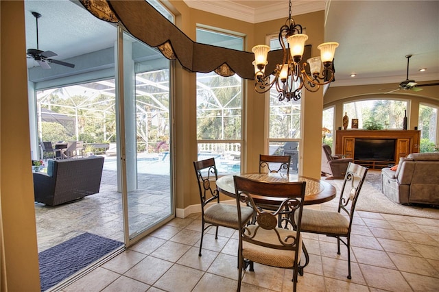 dining space featuring light tile patterned floors, ceiling fan with notable chandelier, and ornamental molding