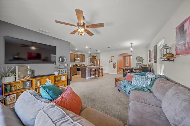 carpeted living room with ceiling fan