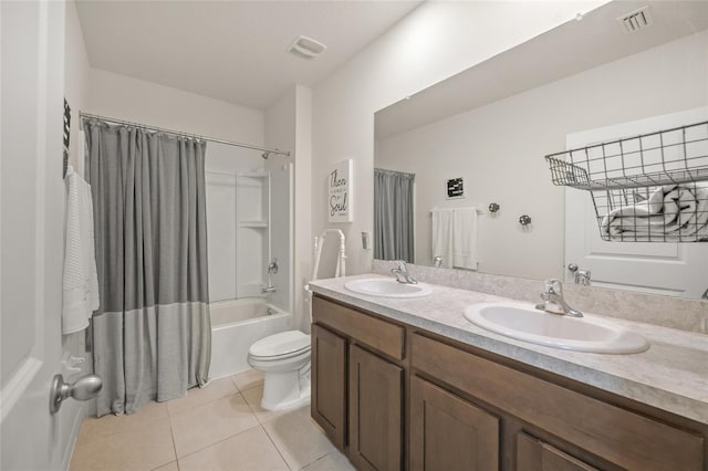 full bathroom featuring tile patterned floors, shower / tub combo with curtain, vanity, and toilet