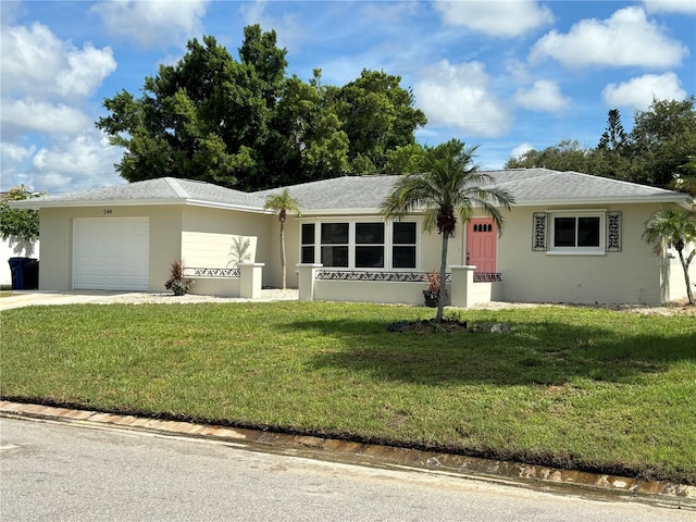 ranch-style home with a front yard and a garage