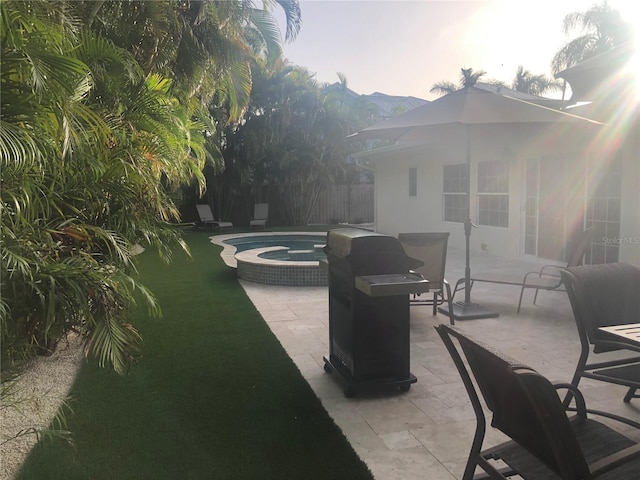 view of patio featuring an in ground hot tub and a mountain view