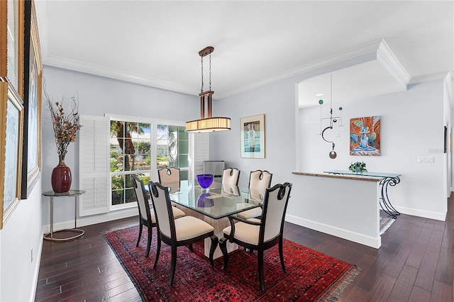 dining area featuring dark hardwood / wood-style floors and crown molding