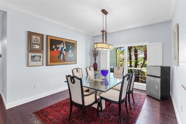 dining room featuring dark wood-type flooring and ornamental molding