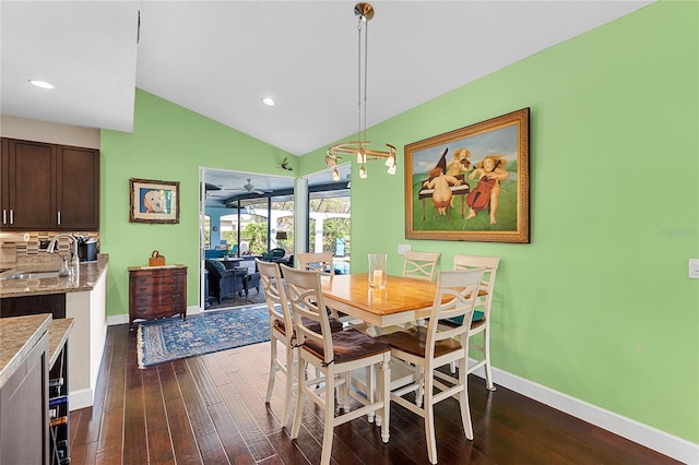 dining area featuring ceiling fan, dark hardwood / wood-style flooring, lofted ceiling, and sink