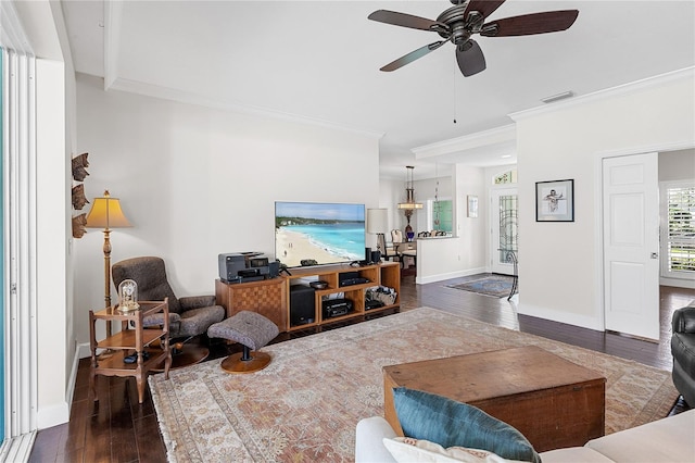 living room with dark wood-type flooring, ceiling fan, and ornamental molding