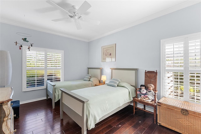 bedroom featuring multiple windows, dark wood-type flooring, ceiling fan, and ornamental molding