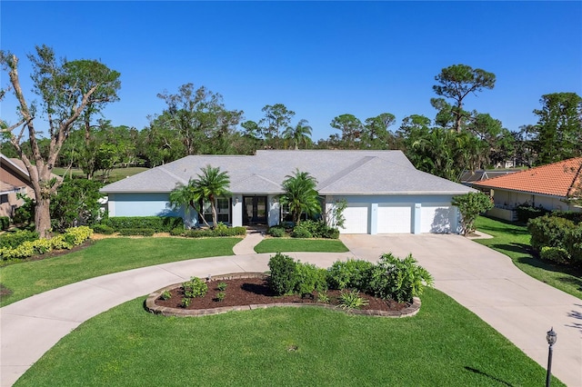 ranch-style home featuring a garage and a front yard