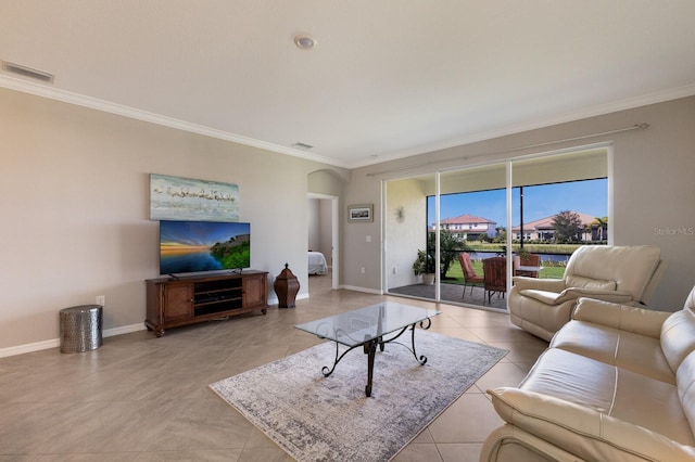 living room with ornamental molding and light tile patterned floors