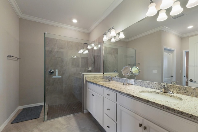 bathroom with crown molding, a tile shower, vanity, and tile patterned floors