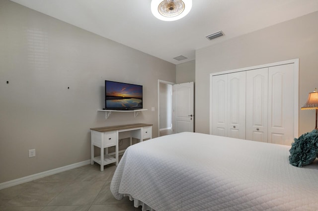 tiled bedroom with a closet