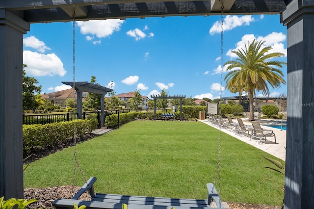 view of yard with a community pool, a pergola, and a patio