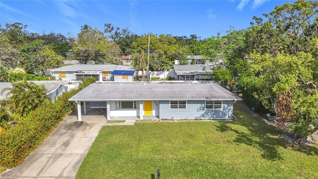 2877 Michigan St, Sarasota, FL 34237 - single story home with driveway, a carport, and a front yard