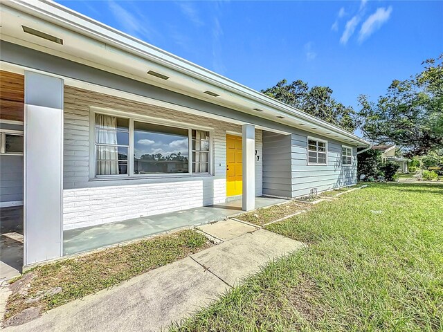 2877 Michigan St, Sarasota, FL 34237 - entrance to property featuring a lawn and a porch