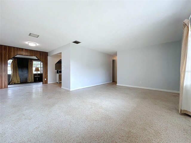 2877 Michigan St, Sarasota, FL 34237 - unfurnished living room featuring baseboards and speckle patterned floor