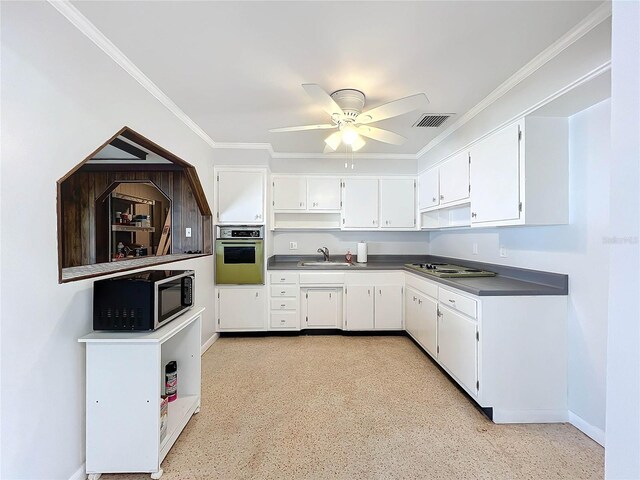 2877 Michigan St, Sarasota, FL 34237 - kitchen with oven, a sink, ceiling fan, dark countertops, and white cabinetry