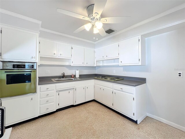 2877 Michigan St, Sarasota, FL 34237 - kitchen featuring wall oven, a sink, dark countertops, ceiling fan, and white cabinets