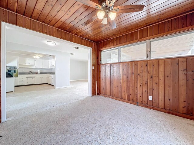 2877 Michigan St, Sarasota, FL 34237 - spare room with a ceiling fan, wooden ceiling, baseboards, and wood walls