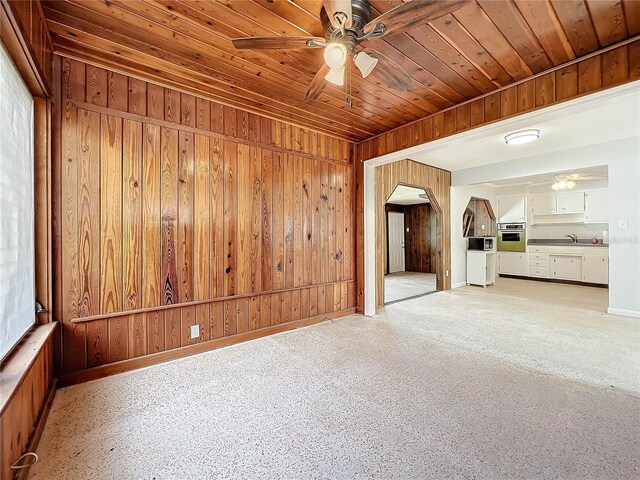 2877 Michigan St, Sarasota, FL 34237 - spare room with a ceiling fan, wooden ceiling, arched walkways, baseboards, and wooden walls