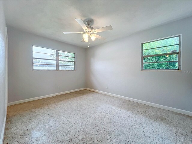 2877 Michigan St, Sarasota, FL 34237 - empty room with ceiling fan, speckled floor, and baseboards