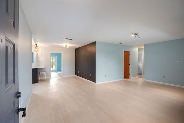 empty room with light hardwood / wood-style flooring