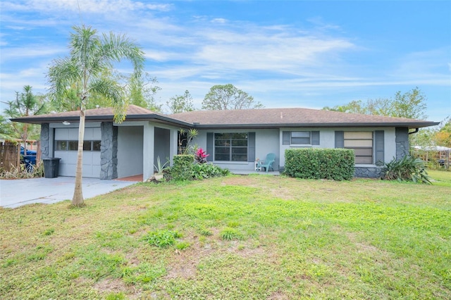 single story home with a garage and a front lawn