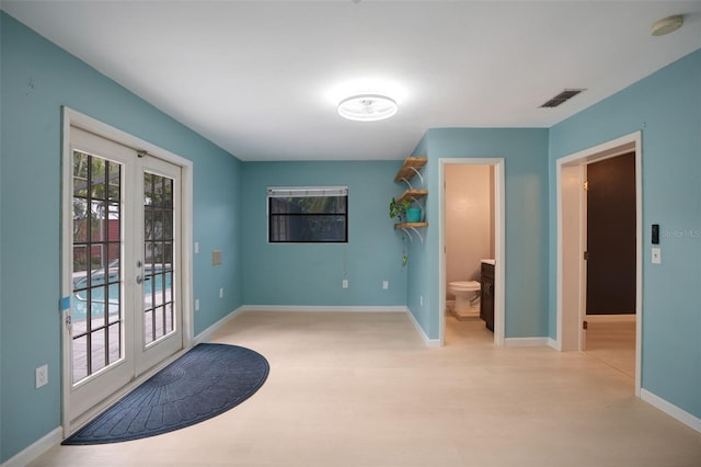 entryway with light wood-type flooring and french doors