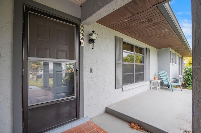 property entrance with covered porch