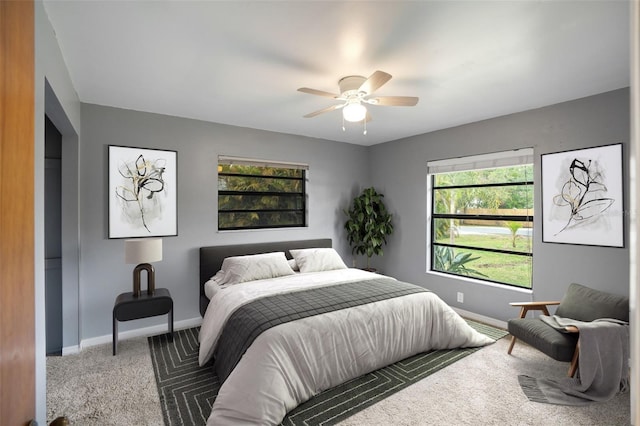 bedroom featuring ceiling fan and dark colored carpet