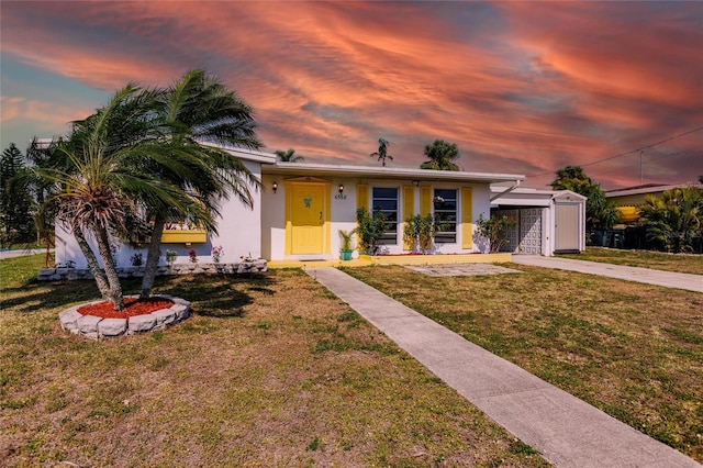 single story home with a lawn